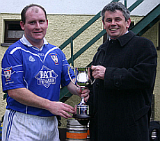 Captain Shane Mc Govern receives the 2005 Div 3b title from County Chairman Martin Skelly